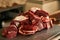 Fresh uncooked sliced meat on scales in meat market