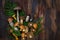 Fresh uncooked wild mushrooms on rustic wooden  background, copy space