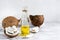 Fresh vegetable coconut oil in a bottle and pieces of coconut on the table. Natural cosmetic