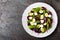 Fresh vegetable salad with boiled beet, mangold leaves, walnuts and quail eggs