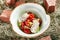 Fresh Vegetable Salad with Fragrant Herb Cheese on Rustic Hay Background