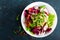 Fresh vegetable salad plate of tomatoes, italian mix, pepper, radish, green sprouts and flax seeds. Vegetarian dish, healthy food.