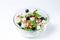 Fresh vegetable salad. Salad in glassware. White background.