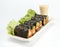 Fresh vegetable spring roll, salad roll in Seaweed tube on ceramic plate, clean food