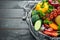 Fresh vegetables on a black background. Avocados, tomatoes, potatoes, paprika, citrus. Top view.