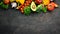 Fresh vegetables on a black background. Avocados, tomatoes, potatoes, paprika, citrus. Top view.