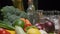 Fresh vegetables, bottles with oil and vinegar, spice jars on the kitchen table