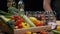 Fresh vegetables, bottles with oil and vinegar, spice jars on the kitchen table