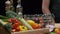 Fresh vegetables, bottles with oil and vinegar, spice jars on the kitchen table