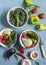 Fresh vegetables - broccoli, peppers, tomatoes, eggplant, squash, turnips on a blue background, top view.