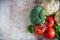 Fresh vegetables: broccoli, ripe tomatoes on a branch, cauliflower inflorescences and fragrant Basil on a beautiful background