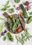 Fresh vegetables - broccoli, zucchini, peppers, beets, green beans and peas, tomatoes on a light background.