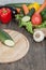 Fresh vegetables on chopping board and dark table. Zucchini cut into pieces, over a wooden table made a composition of vegetables