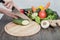 Fresh vegetables on chopping board and dark table. Zucchini cut into pieces, over a wooden table made a composition of vegetables