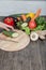 Fresh vegetables on chopping board and dark table. Zucchini cut into pieces, over a wooden table made a composition of vegetables