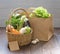 Fresh vegetables in a craft bag on a dark wooden background. The concept of healthy vegetarian food from the market or delivery