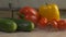 Fresh vegetables, cucumbers, tomatoes and paprika lie on the table in the kitchen from which blows cool and fresh, close