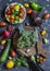 Fresh vegetables on dark background - broccoli, tomatoes, peppers, beets, eggplant, radish. Vegetarian table.