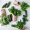 Fresh vegetables in eco cotton bags, paper package on table in the kitchen. Cucumbers, salad, kale, basil, rucola from organic