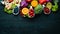 Fresh vegetables and fruits on a black background. Vitamins and minerals. Top view.