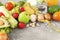 Fresh vegetables and fruits with centimeter ribbon on gray background, avocado, tomato, zucchini, sesame, onion, radish, nuts,