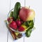 Fresh vegetables and fruits in a glass bowl. Strawberry, apple, cucumber, lemon and mint.