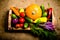 Fresh vegetables and herbs on a wooden burned rustic texture for