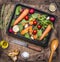 Fresh vegetables and ingredients for cooking in vintage wooden box on rustic background, top view, place text. Vegan food , ve