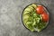 Fresh vegetables in a plate - salad mix, tomatoes and zuchinni. Healthy food concept, lose weight