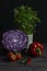 Fresh vegetables red cabbage paprika tomatoes chilli peppermint still life low key. Cut red cabbage, green red hot chili
