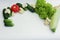 Fresh vegetables tomatoes, zucchini, cucumbers, cauliflower on a white background lie in a semicircle and there is a place for the