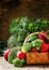 Fresh vegetables in a wicker basket: tomatoes, broccoli, cucumbe