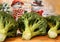 Fresh vegetables in winter on the green table: green heads of garden cabbage broccoli, onion pods of leeks against the background