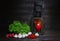 Fresh vegetables on a wooden background. A green salad, radishes, mushrooms and tomatoes on a table