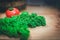 Fresh vegetables on wooden background. Kale and tomato.