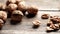 Fresh walnut kernels and whole walnuts in a bowl on rustic old wooden table in 4K VIDEO
