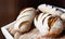 Fresh and warm. Closeup of a pile of freshly-baked bread loaves.