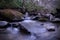 Fresh Water River with Slow Shutter Speed Photography and Rocks with Moss.