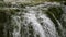 Fresh water spring waterfall in mountain forest.