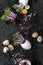 Fresh watercress salad in eggshell and quail eggs on a wet black background