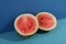 Fresh watermelon halves on two tone background