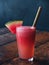 Fresh watermelon juice in a glass with a cane straw
