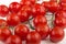 Fresh and wet piccolo tomatoes on bright background