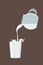 A fresh white cow`s milk pours from a decanter into a glass