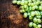Fresh white grapes over wood table macro. Bunch of Grapes on a