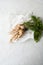 Fresh white parsley roots on white paper