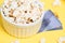 Fresh white popcorn. Yellow background. White plate