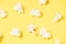 Fresh white popcorn. Yellow bright background. Fried Corn