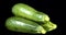 Fresh whole zucchini on the table slowly rotating.