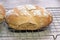 Fresh wholegrain bread cooling on a wire tray.